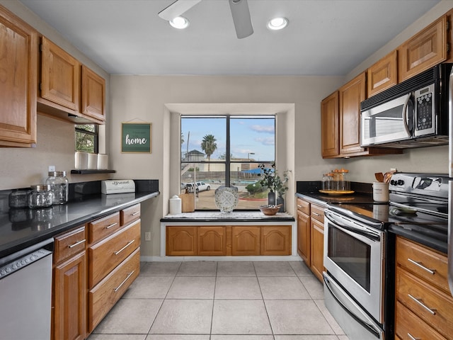 kitchen with plenty of natural light, light tile patterned flooring, and stainless steel appliances