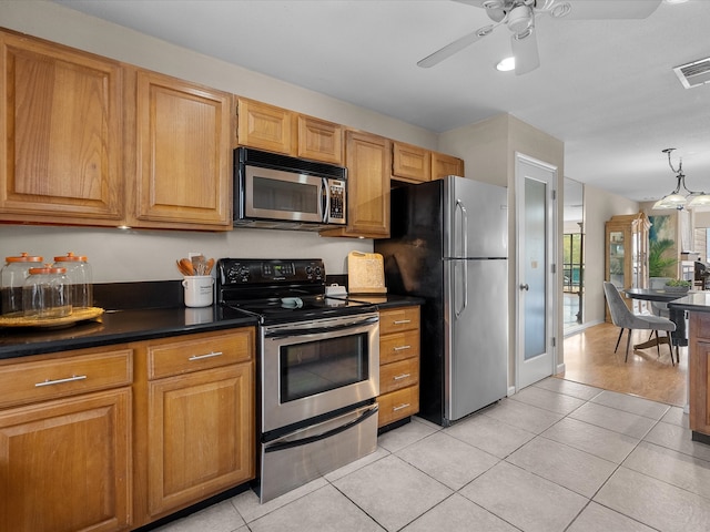 kitchen with appliances with stainless steel finishes, light tile patterned floors, and ceiling fan