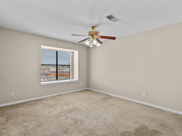 carpeted empty room with ceiling fan