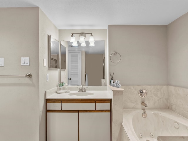 bathroom with a bathing tub, vanity, and a textured ceiling