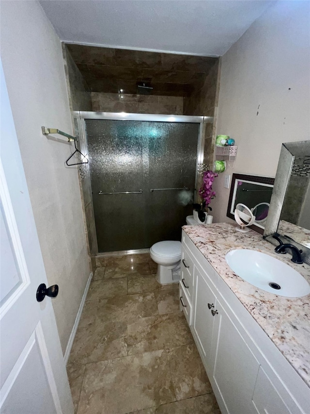 bathroom with vanity, toilet, and walk in shower