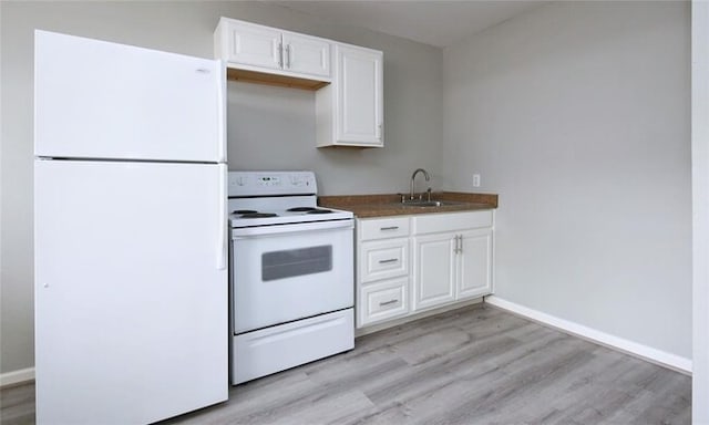 kitchen with white cabinetry, sink, white appliances, and light hardwood / wood-style flooring