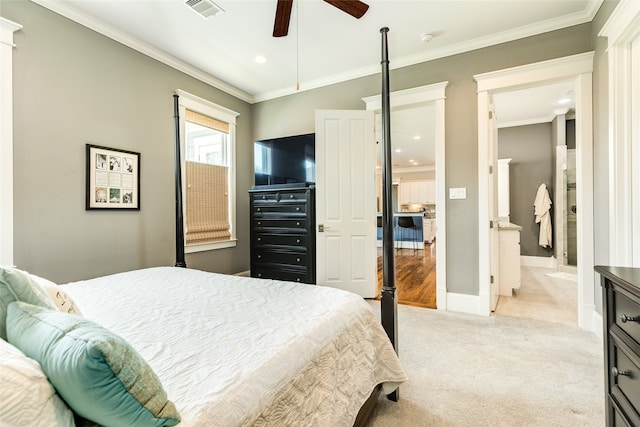 carpeted bedroom with ceiling fan and crown molding