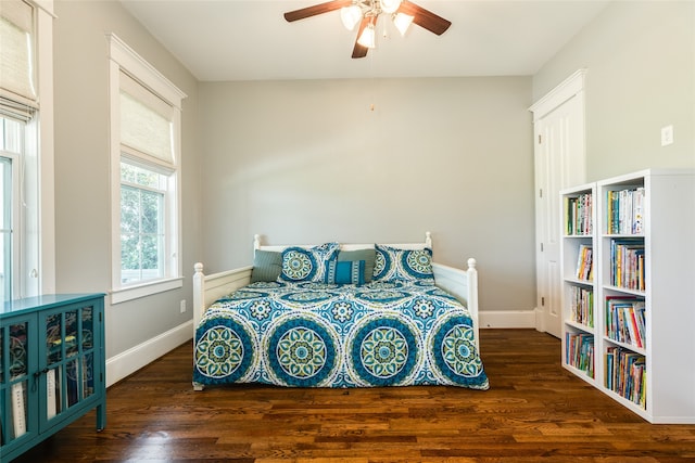 bedroom with ceiling fan and dark hardwood / wood-style flooring