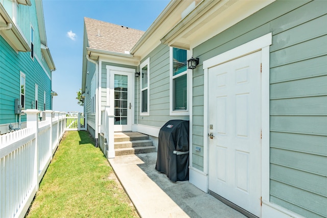 doorway to property with a yard