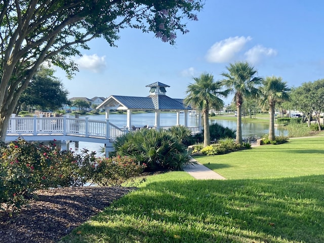 view of property's community featuring a water view, a gazebo, and a lawn