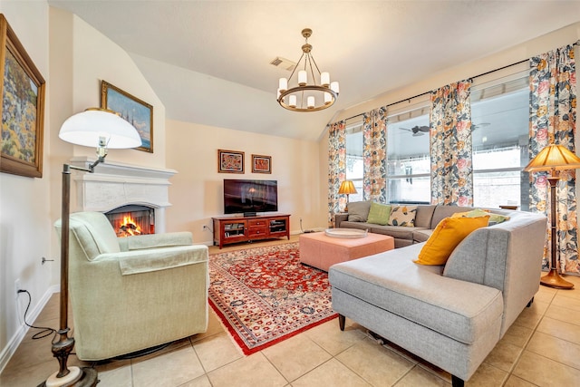 living room featuring vaulted ceiling, light tile patterned floors, a healthy amount of sunlight, and a notable chandelier