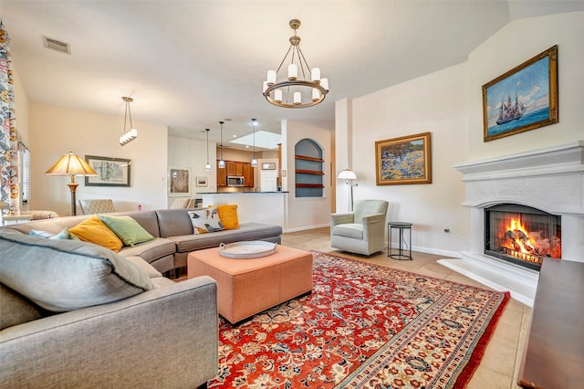 tiled living room with an inviting chandelier