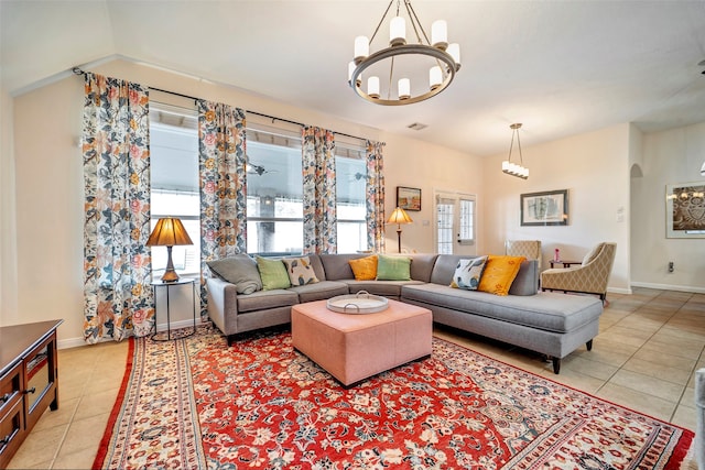 living room featuring light tile patterned floors and a notable chandelier