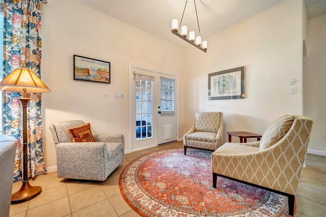 living area with lofted ceiling and tile patterned floors