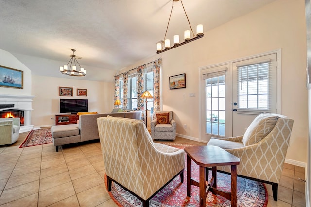 tiled living room with an inviting chandelier and lofted ceiling