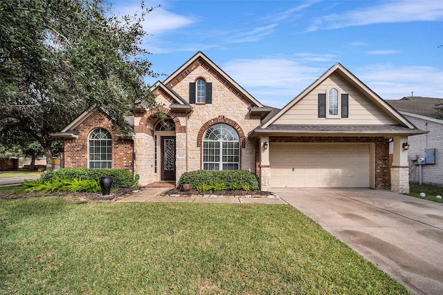 view of front of property with a garage and a front yard