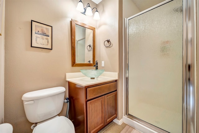 bathroom with tile patterned flooring, vanity, toilet, and an enclosed shower