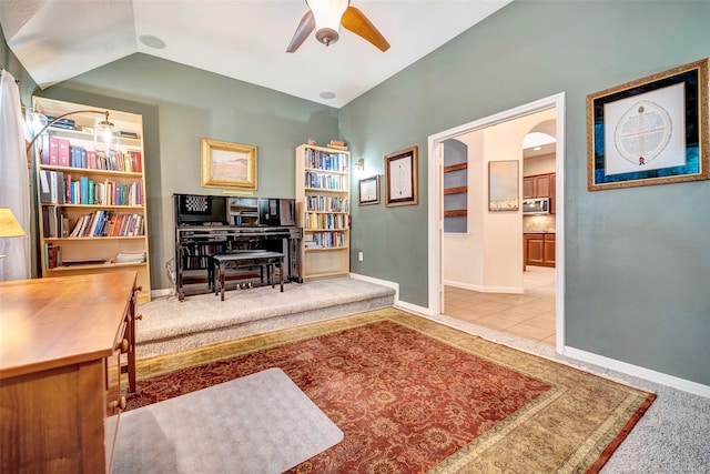 living area with ceiling fan and light colored carpet