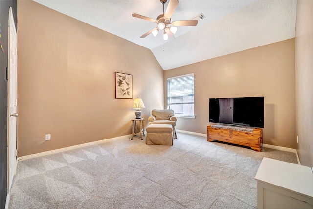 sitting room with lofted ceiling, light carpet, and ceiling fan