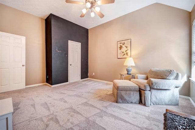 living area with ceiling fan, light carpet, and lofted ceiling