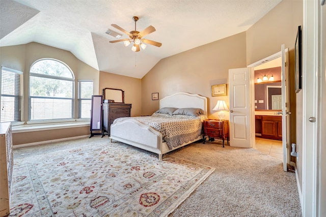 carpeted bedroom with ceiling fan, connected bathroom, a textured ceiling, and lofted ceiling