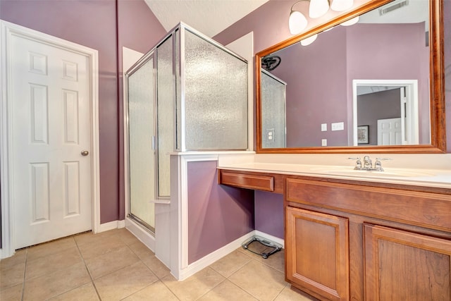 bathroom with vanity, tile patterned floors, and a shower with shower door