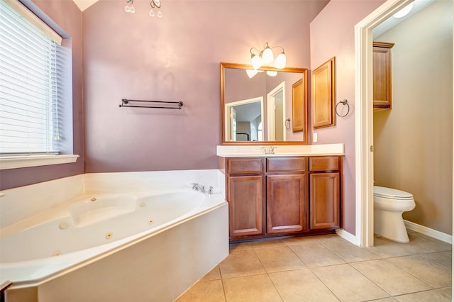 bathroom featuring toilet, a washtub, vanity, and tile patterned flooring