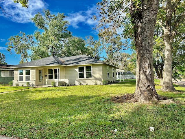 ranch-style house with brick siding and a front yard