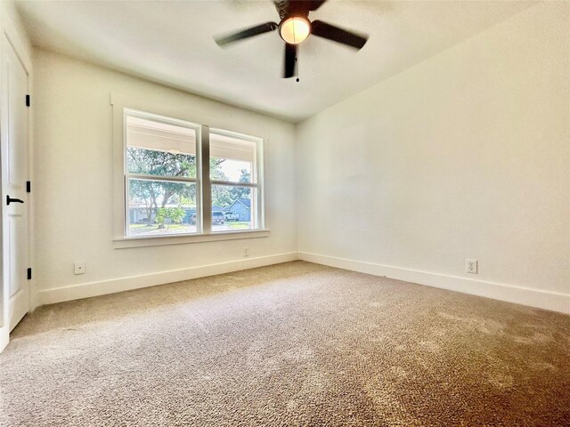 unfurnished room featuring ceiling fan and carpet floors