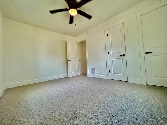 unfurnished bedroom with ceiling fan and light carpet