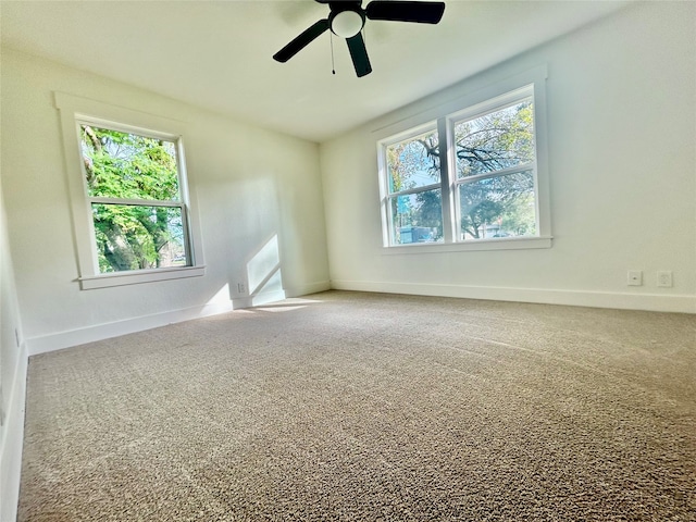 carpeted empty room featuring ceiling fan