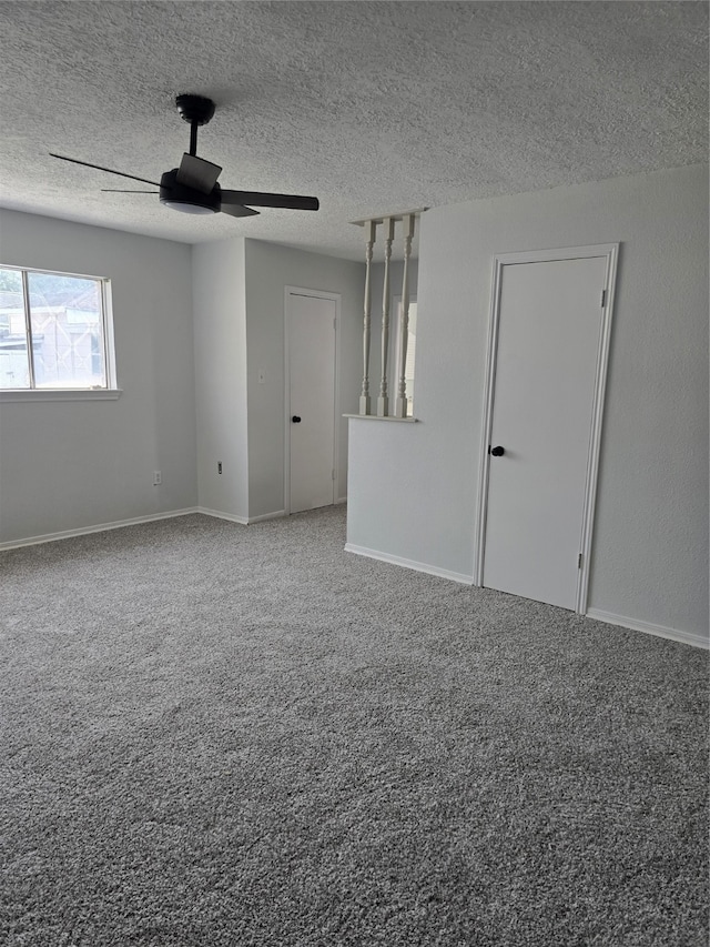 spare room featuring carpet, ceiling fan, and a textured ceiling