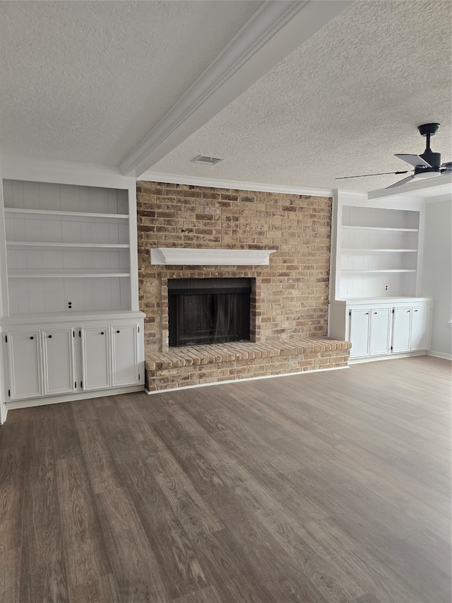 unfurnished living room featuring a textured ceiling, ceiling fan, and dark wood-type flooring