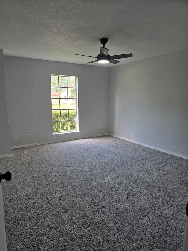 carpeted empty room featuring a textured ceiling and ceiling fan