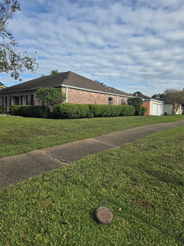 view of property exterior featuring a garage and a yard