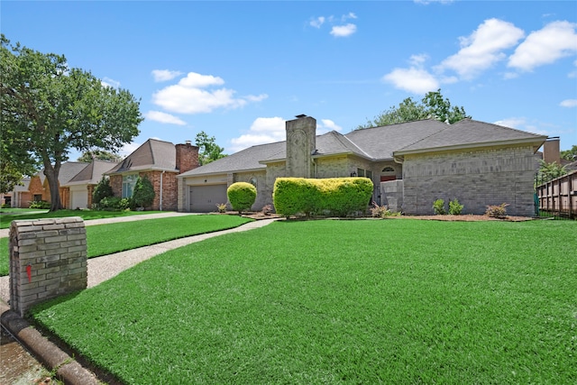 ranch-style home with a front lawn and a garage