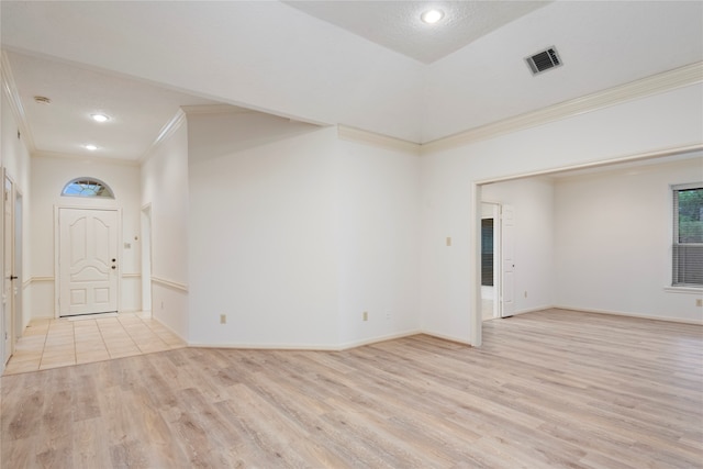 entryway with light wood-type flooring and ornamental molding