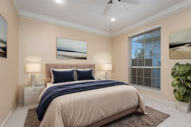 carpeted bedroom featuring ceiling fan, a textured ceiling, and ornamental molding