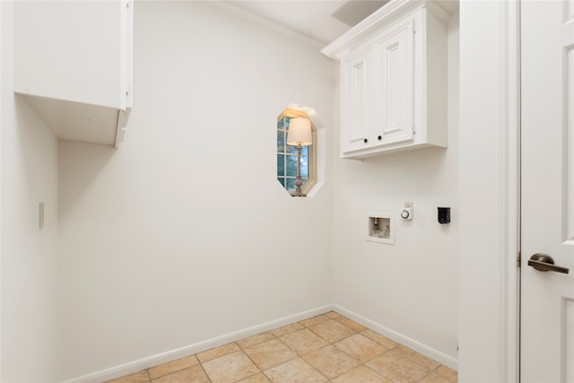 washroom with crown molding, washer hookup, light tile patterned floors, cabinets, and electric dryer hookup