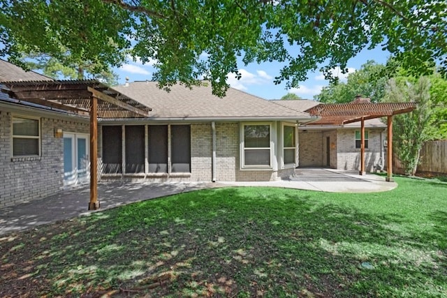 rear view of house with a yard and a patio area