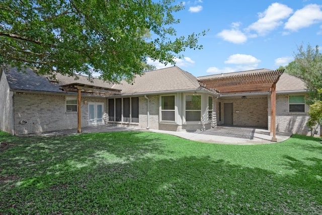 rear view of house with a yard and a patio area