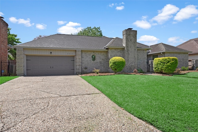 single story home with a garage and a front lawn