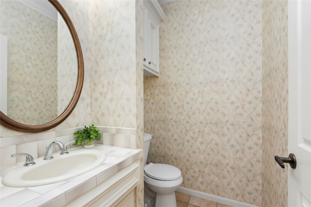 bathroom with toilet, vanity, and tile patterned flooring