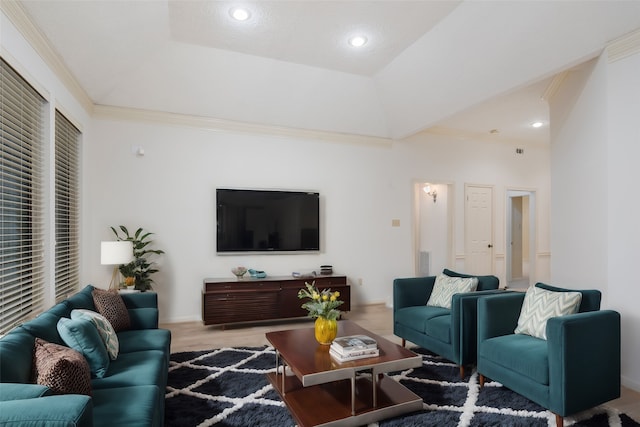 living room featuring a raised ceiling, light hardwood / wood-style floors, and crown molding