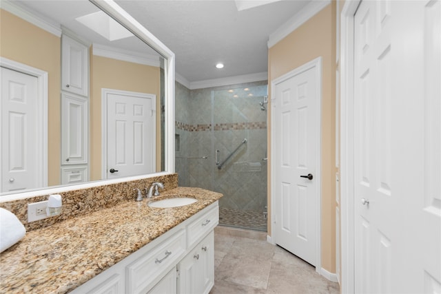 bathroom featuring a shower with door, tile patterned flooring, ornamental molding, a skylight, and vanity