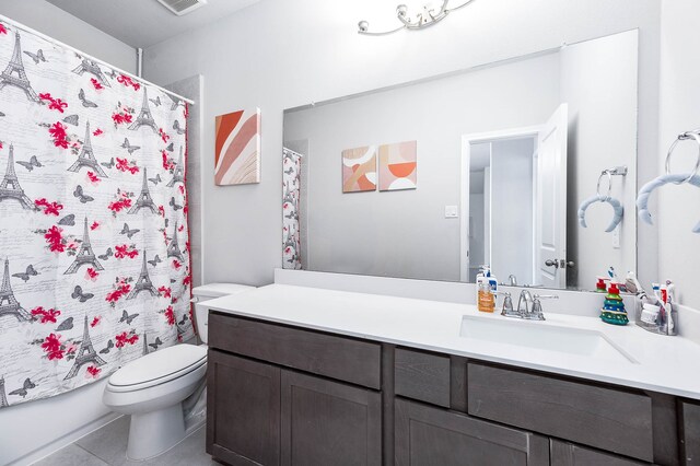 full bathroom featuring tile patterned flooring, vanity, toilet, and shower / bathtub combination with curtain