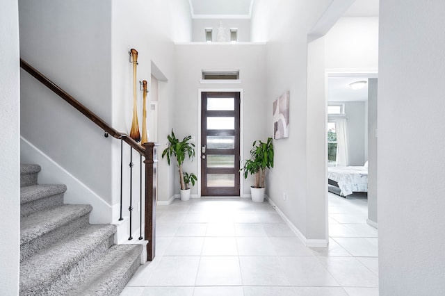 tiled foyer entrance with a high ceiling