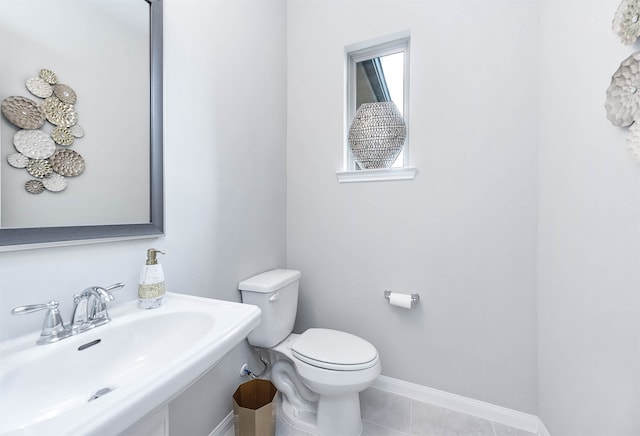 bathroom with tile patterned flooring, sink, and toilet