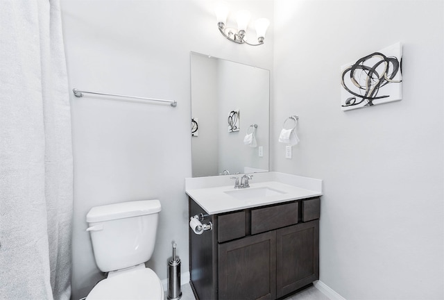 bathroom featuring toilet and vanity