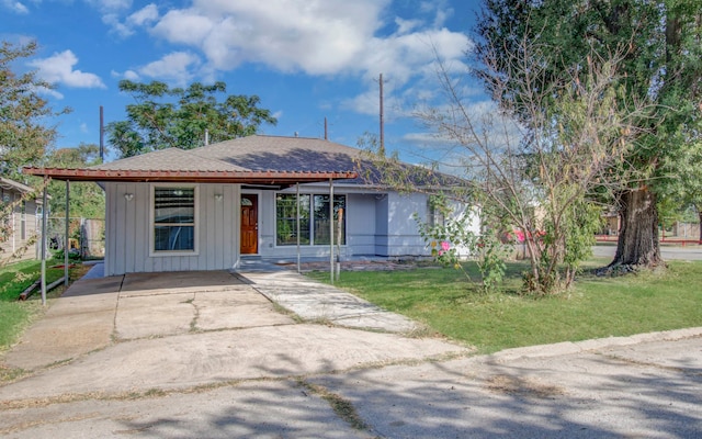 single story home with a carport and a front lawn