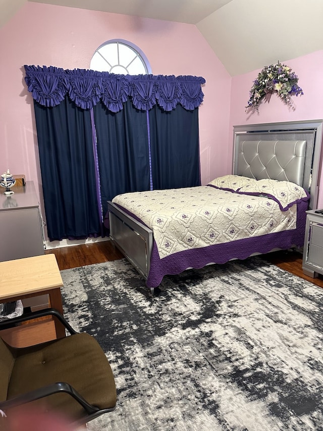 bedroom with dark wood-type flooring and vaulted ceiling