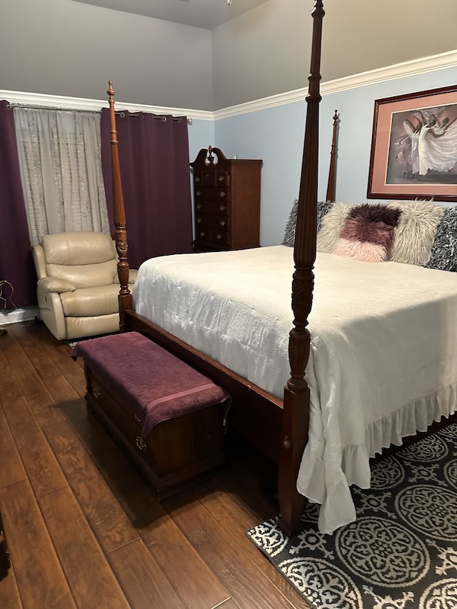 bedroom with dark hardwood / wood-style flooring