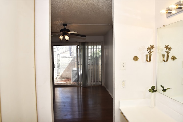 interior space with wood-type flooring, ceiling fan, and a textured ceiling