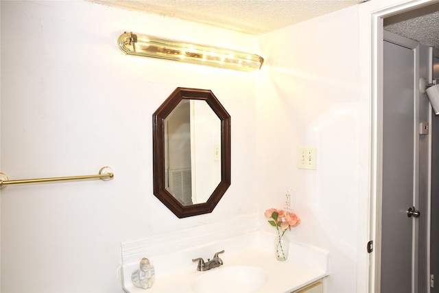 bathroom featuring vanity and a textured ceiling